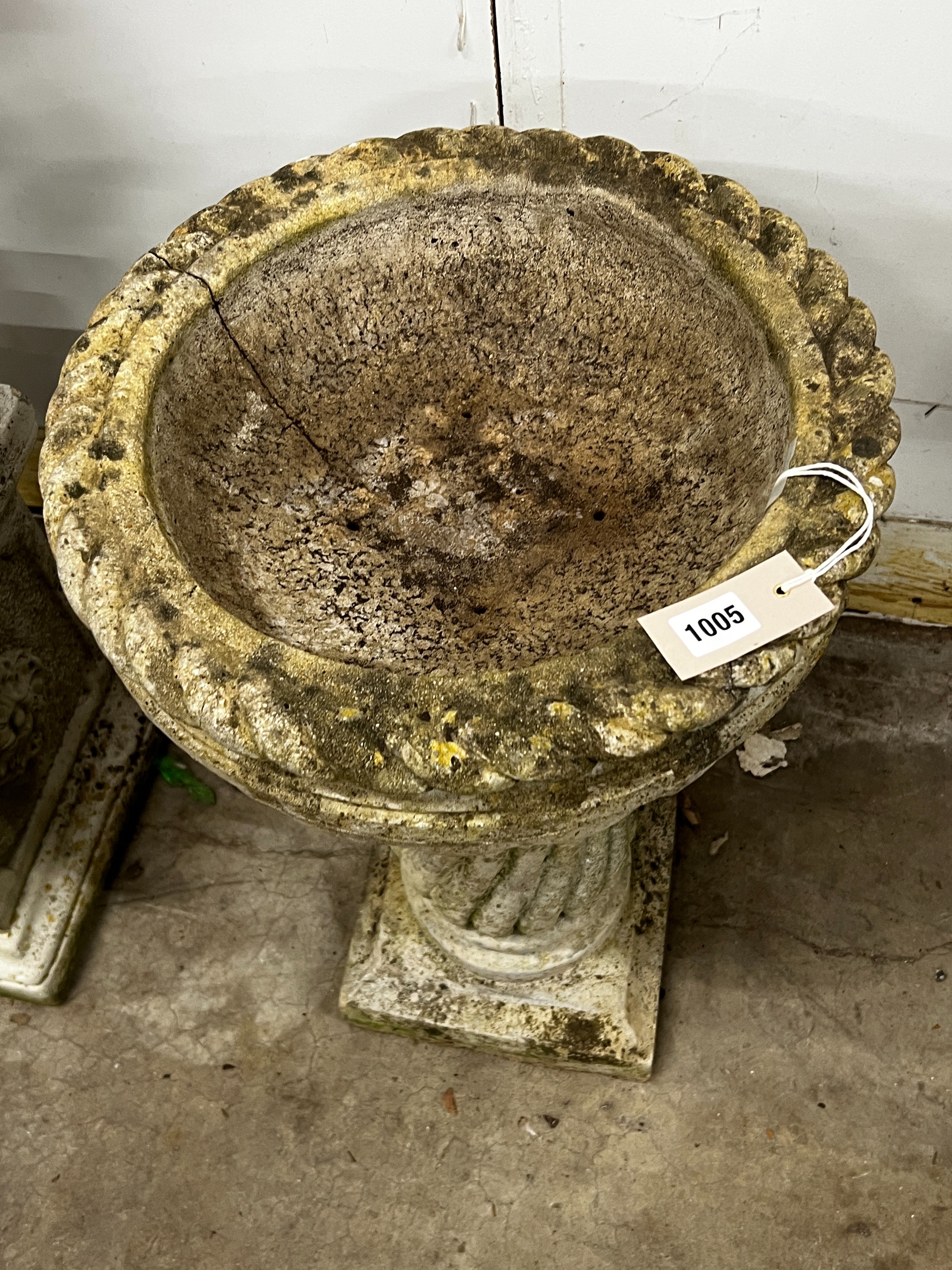 A circular reconstituted bird bath, diameter 40cm, height 65cm